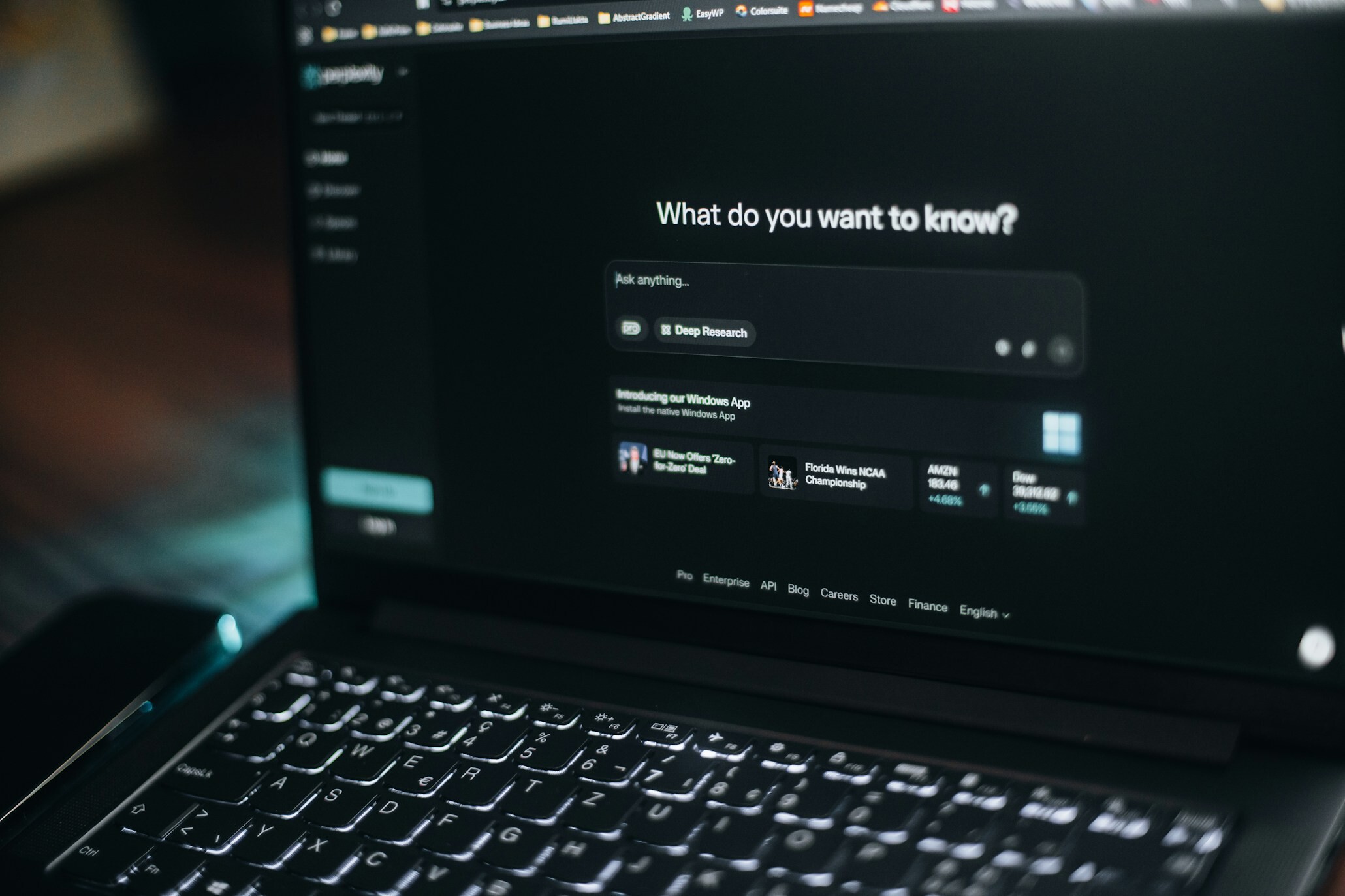 Laptop screen showing an AI (LLM) search bar.